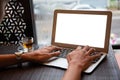 Young entrepreneur SME use notebook showing blank screen with clipping path display in cafe concept.ÃÂ Hand of business man hold